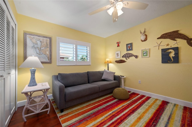 living room featuring ceiling fan and hardwood / wood-style flooring