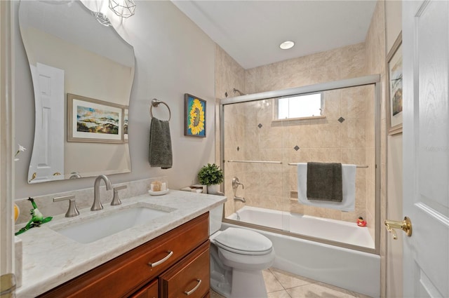 full bathroom featuring combined bath / shower with glass door, vanity, toilet, and tile patterned flooring