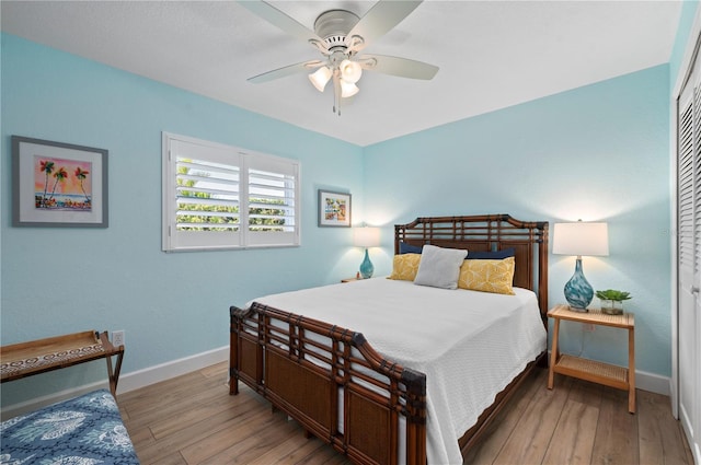 bedroom with ceiling fan, a closet, and light wood-type flooring