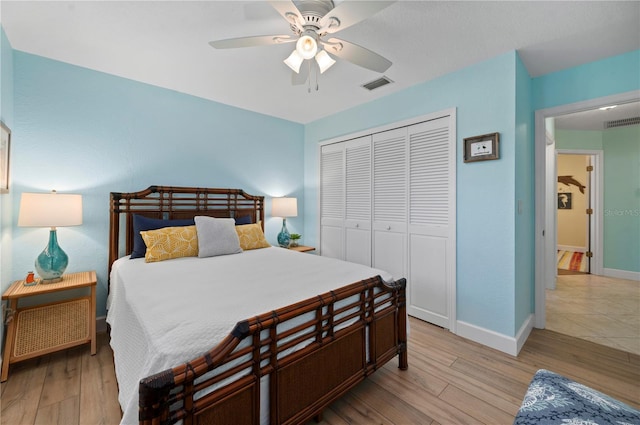 bedroom featuring ceiling fan, a closet, and light hardwood / wood-style floors