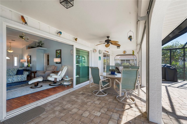 view of patio with ceiling fan, a lanai, and grilling area