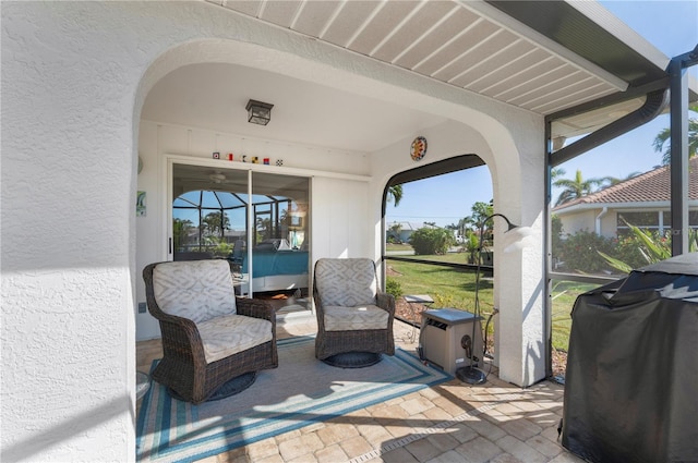 view of patio with a lanai and grilling area