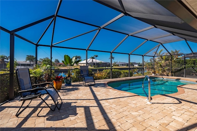 view of pool featuring glass enclosure and a patio