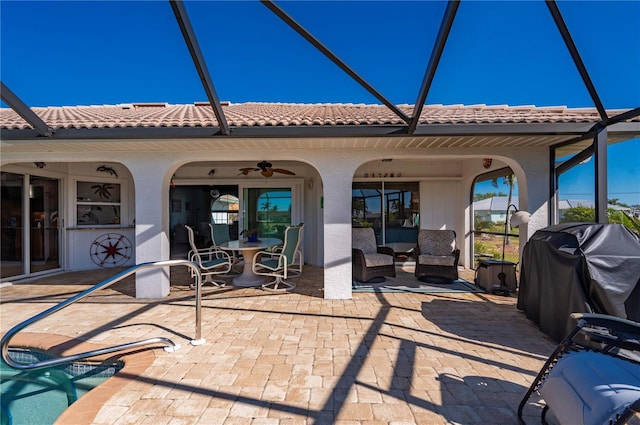 back of house with ceiling fan and a patio area