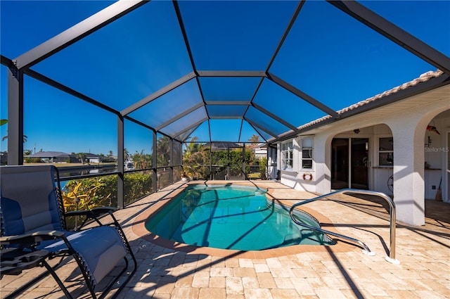 view of pool featuring a lanai and a patio