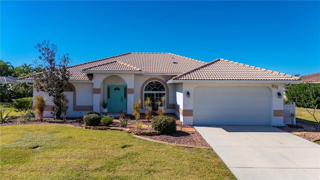 mediterranean / spanish-style home featuring a front lawn and a garage