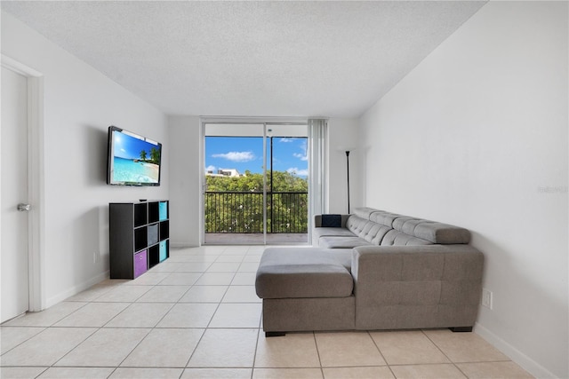 living room with light tile patterned flooring and a textured ceiling