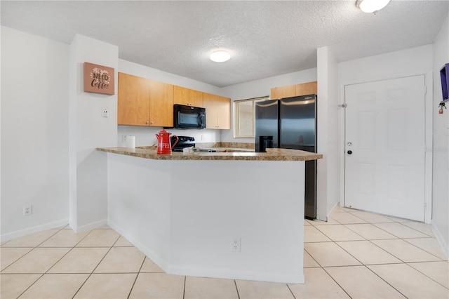 kitchen featuring kitchen peninsula, light tile patterned floors, a textured ceiling, and stainless steel appliances