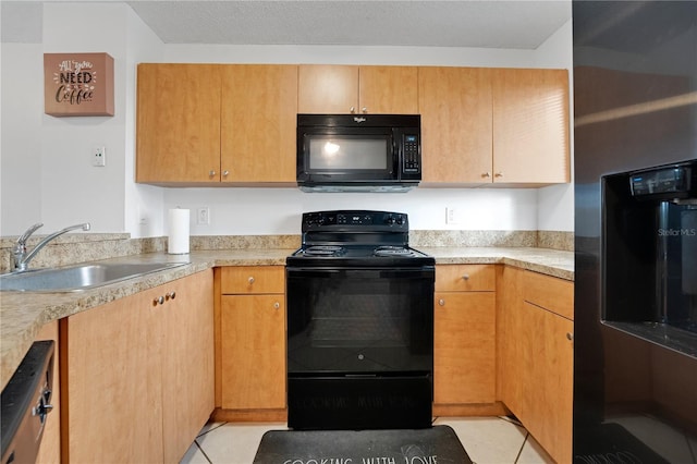 kitchen with light tile patterned floors, sink, and black appliances