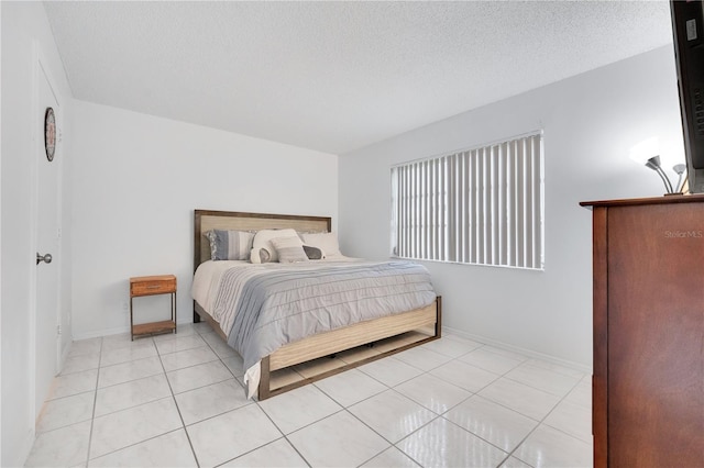 tiled bedroom featuring a textured ceiling