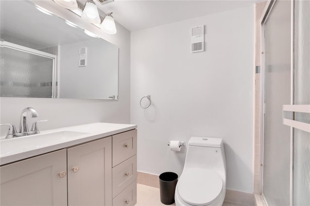 bathroom with vanity, toilet, and a shower with shower door