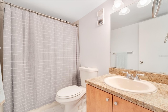 bathroom featuring tile patterned flooring, vanity, and toilet