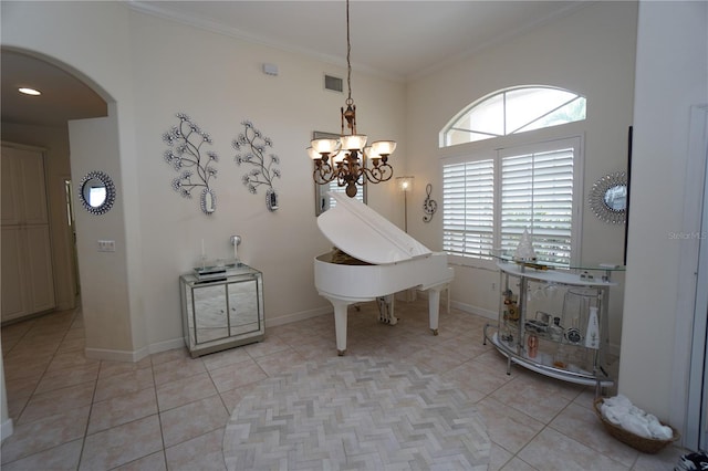 interior space featuring tile patterned floors, crown molding, and a notable chandelier