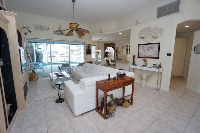 living room with light tile patterned floors, ceiling fan, and crown molding