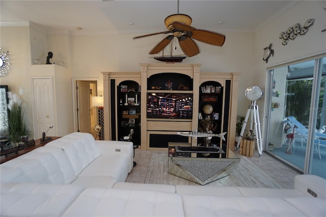 living room with ceiling fan, crown molding, and a towering ceiling