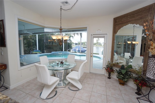 dining space featuring a notable chandelier and light tile patterned floors