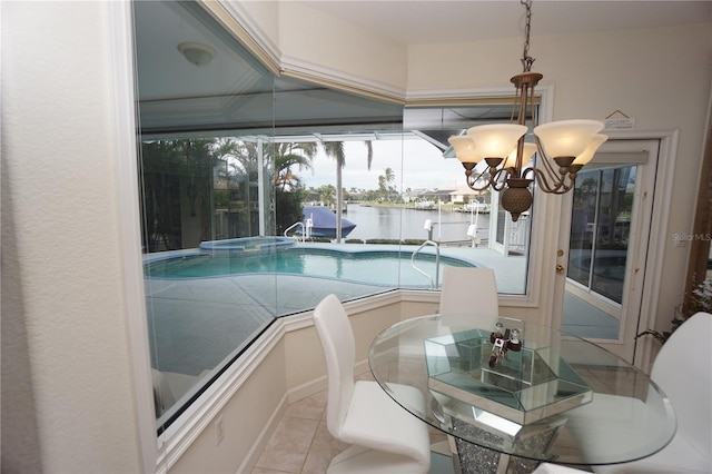 view of swimming pool featuring a water view and a notable chandelier