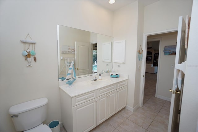 bathroom with tile patterned flooring, vanity, and toilet