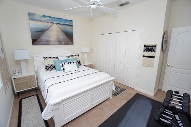 carpeted bedroom featuring a closet and ceiling fan