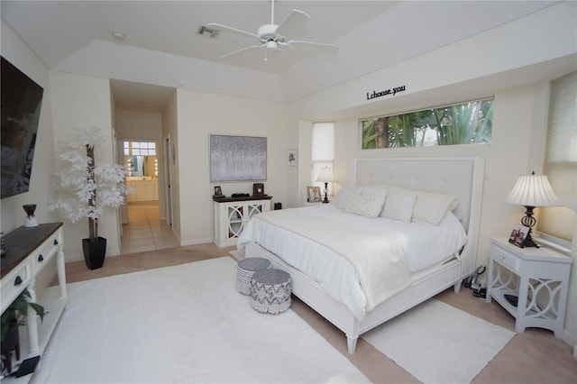 bedroom with connected bathroom, ceiling fan, and light tile patterned floors