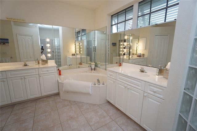 bathroom featuring tile patterned flooring, vanity, and a tub to relax in