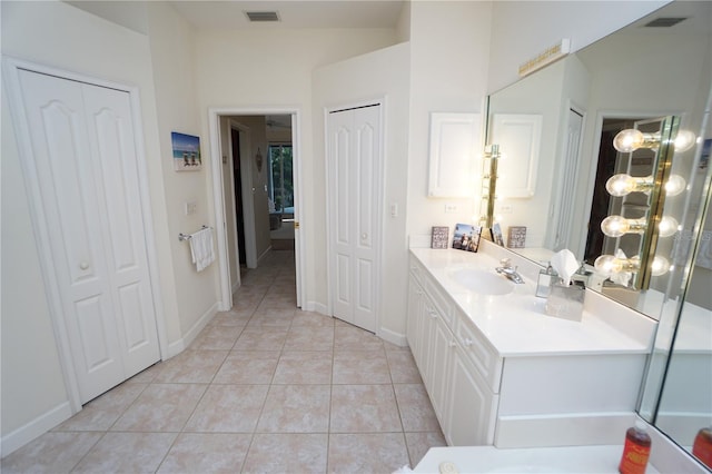 bathroom featuring tile patterned flooring, vanity, and a chandelier