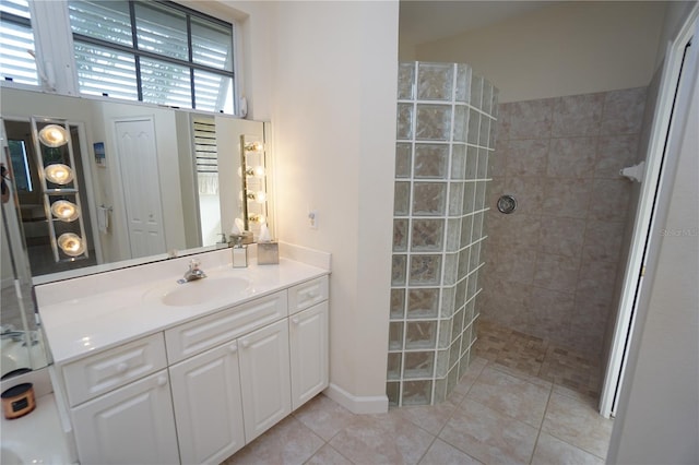 bathroom featuring tile patterned floors, vanity, and tiled shower