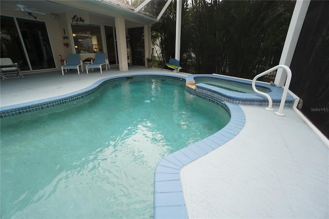 view of swimming pool featuring an in ground hot tub and a patio