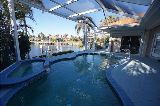 view of pool with an in ground hot tub, a dock, a water view, glass enclosure, and a patio area