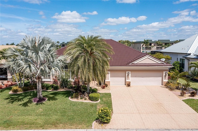 view of front of property featuring a garage and a front lawn