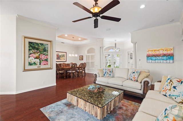 living room featuring ornate columns, ceiling fan, dark hardwood / wood-style floors, and ornamental molding