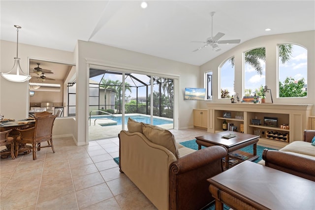 tiled living room with ceiling fan and vaulted ceiling