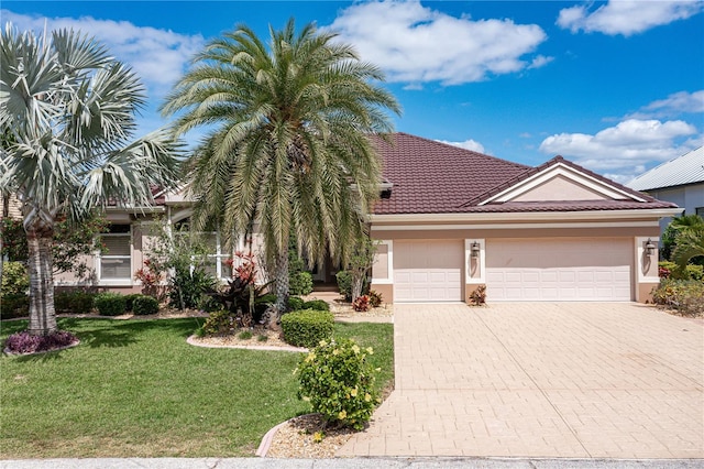 view of front facade featuring a front yard and a garage