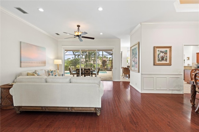 living room with crown molding, ceiling fan, and dark hardwood / wood-style floors