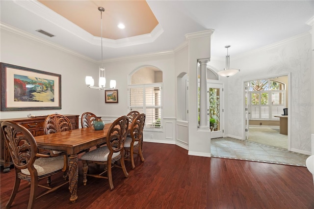 dining room with crown molding, dark wood-type flooring, and an inviting chandelier