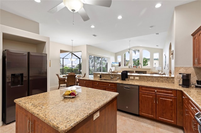 kitchen featuring a center island, sink, vaulted ceiling, appliances with stainless steel finishes, and plenty of natural light