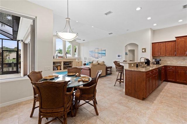 dining area with light tile patterned floors and sink