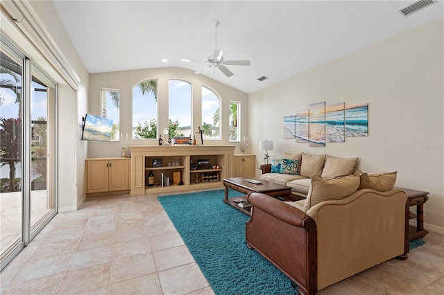 tiled living room with ceiling fan and lofted ceiling