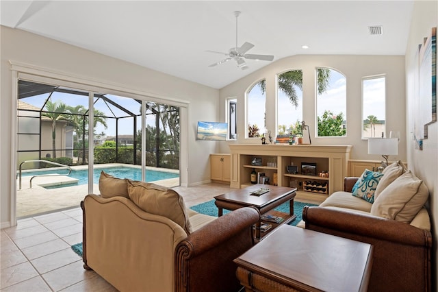 tiled living room featuring ceiling fan and vaulted ceiling