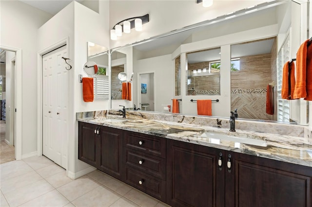 bathroom featuring tile patterned floors, vanity, and tiled shower