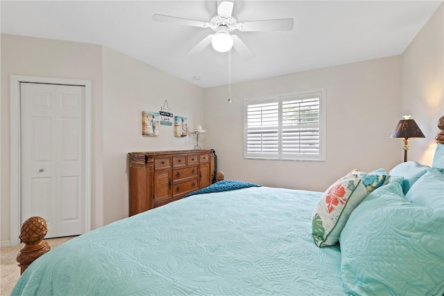 carpeted bedroom with ceiling fan and a closet