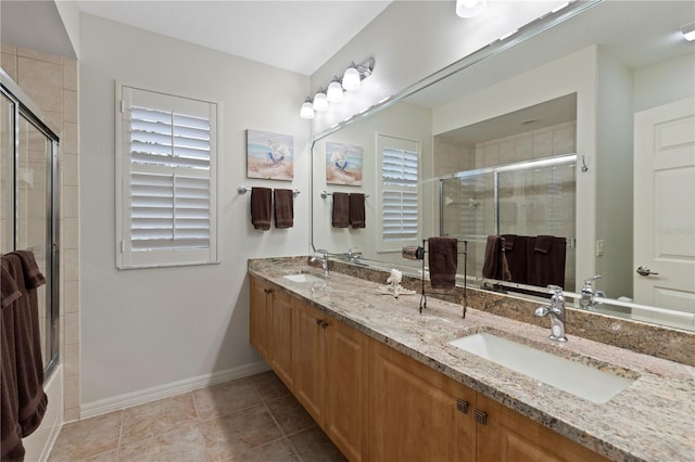 bathroom featuring tile patterned floors, vanity, and shower / bath combination with glass door