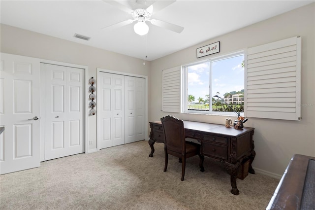 office featuring ceiling fan and light carpet