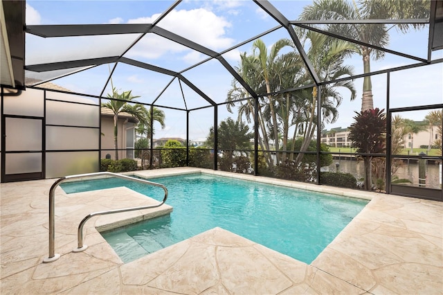 view of pool with glass enclosure, a patio area, and a water view