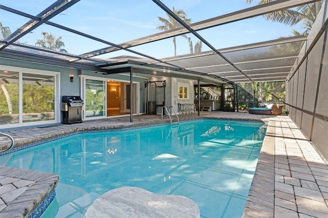 view of swimming pool featuring a patio, area for grilling, and a lanai