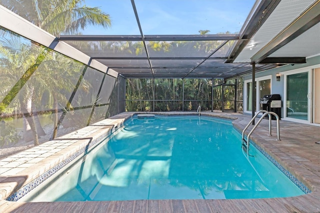 view of swimming pool with a patio and glass enclosure