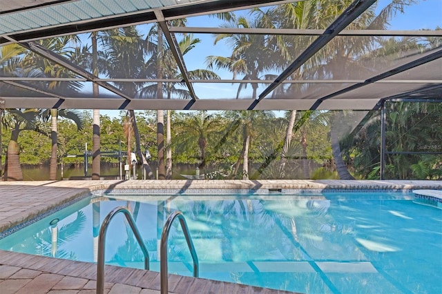 view of swimming pool with glass enclosure and a patio