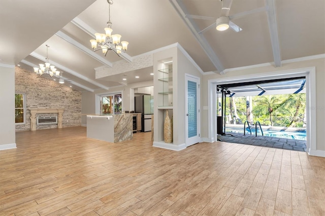 unfurnished living room with ceiling fan with notable chandelier, lofted ceiling with beams, light hardwood / wood-style flooring, and ornamental molding