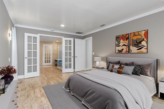 bedroom with light wood-type flooring, crown molding, and french doors