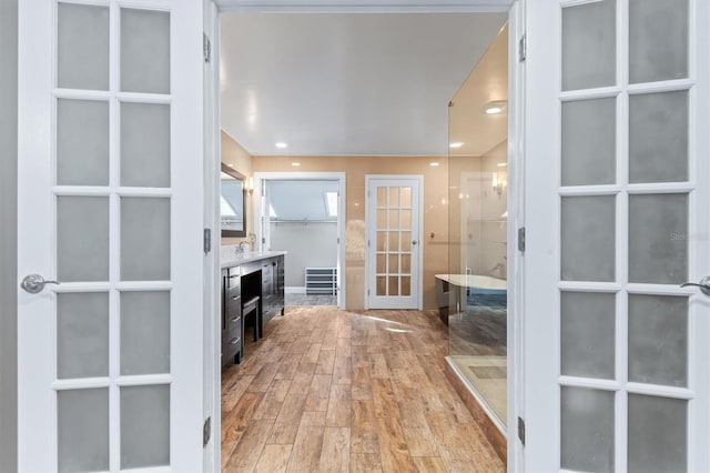 interior space with french doors and light wood-type flooring